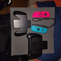 Pair of Joy Con Switch Controllers, A Joy Con Charging Grip And A Joy Con Comfort Grip 