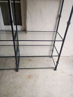 Wrought iron and glass shelving unit