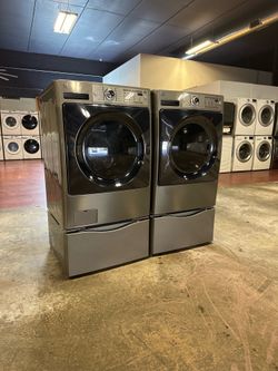 Kenmore elite front-loading washer and dryer set with pedestal and you can also use it as a stackable everything works and very clean you can see it w