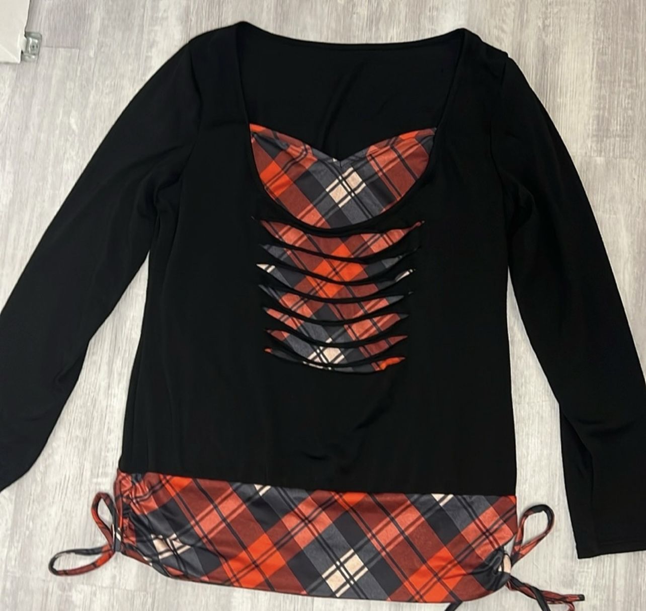 Long sleeve red and black plaid pattern ruched drawstring funnel neck shirt.