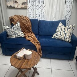 Blue velvet sofa with pull out bed
