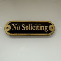 metal “No Soliciting” sign