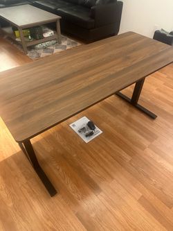 Electric, adjustable brown desk