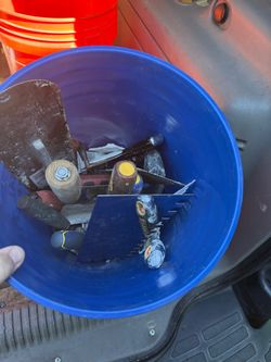Bucket of trowels and spackle knives and more