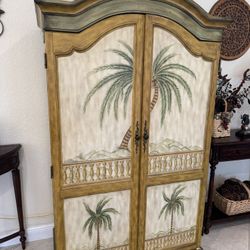 Palm Tree Decorated TV Armoire features a coastal design with hand-painted tropical scenes