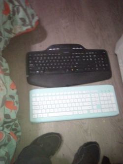 Two Computer Keyboards black and baby blue