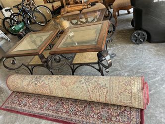 Set of glass top coffee tables and a rolled area rug