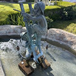 Children on latter bronze statue fountain
