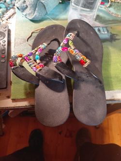 pair of black Pali Hawaii sandals with multi-colored beaded straps. Size 8