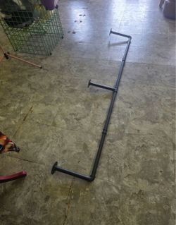 Used wall garment rack,just over 5 feet long. $20