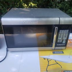Stainless steel Cuisinart microwave with a riser, turkey forks and baster and knife sharpener. 