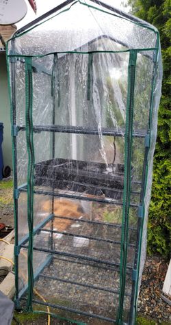 Mini greenhouse with growing trays and plastic pots