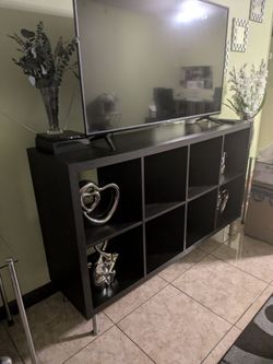 Drak brown TV stand, items not included.