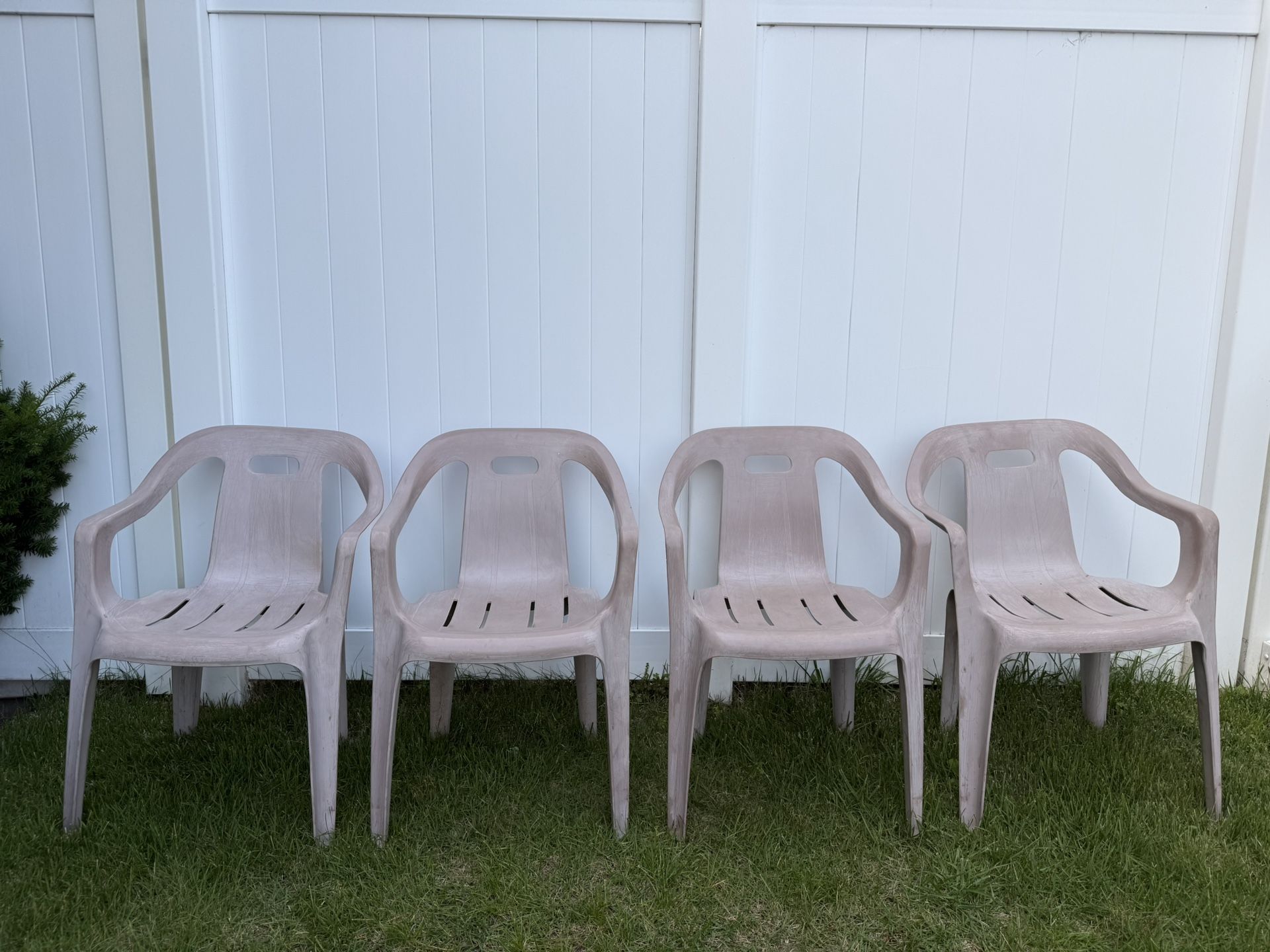 Four outdoor stackable chairs