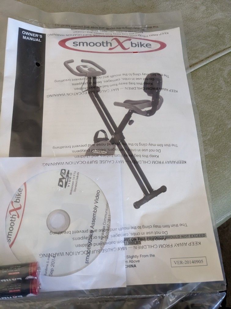 NEW IN BOX SMOOTH X BRAND EXERCIZE BIKE- FOLDING 300 LB CAPACITY - BLACK & PURPLE