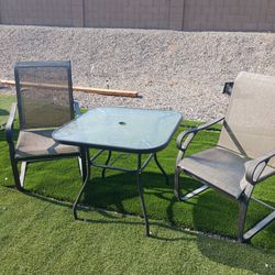 Clean outdoor glass top table with 2 chairs asking $130 cash