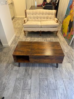 Modern Lift-Top Coffee Table with Hidden Storage  Beautiful modern coffee table in excellent condition. Features a lift-top design that raises to a co