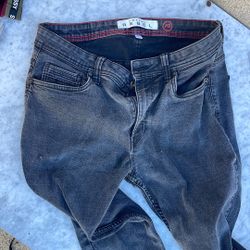 The jeans in the image are made by the brand Artful Rebel. Artful Rebel produces a variety of high-performance luxury clothing