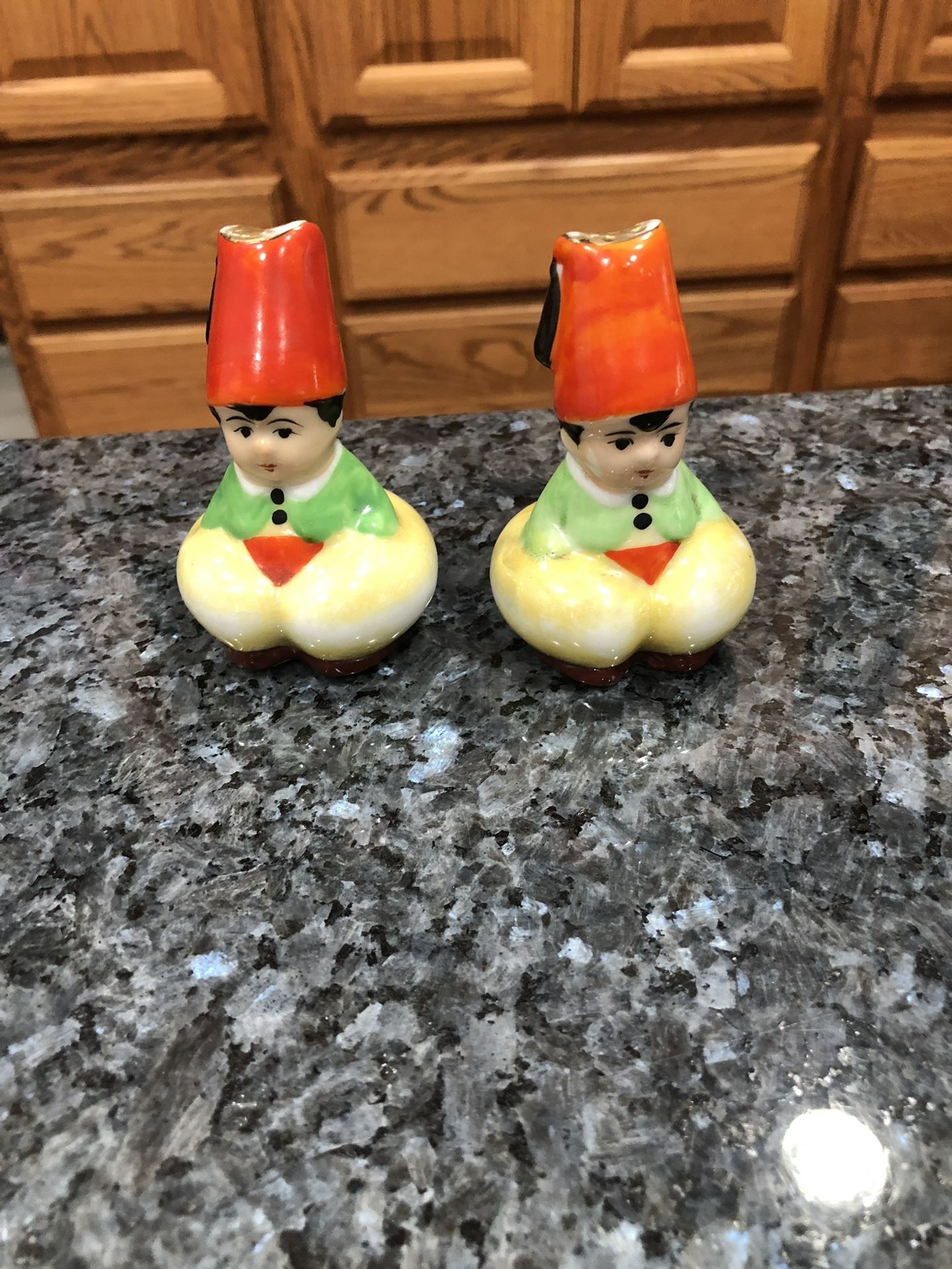 Vintage Porcelain pair of Salt and Pepper Shakers. No stoppers see pictures. Size 3 inches. Made in Japan. Preowned good condition.