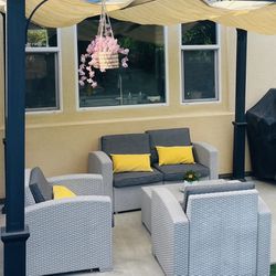 4 Piece Rattan Patio furniture Grey, Couch, 2 Chairs, And Table. Pillows Not Included. 
