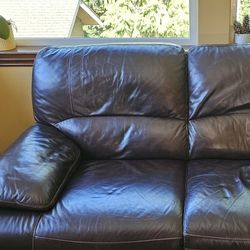 A reclinable leather sofa and love seat