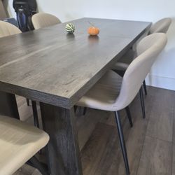 Modern dark wood dining table set — includes chairs.