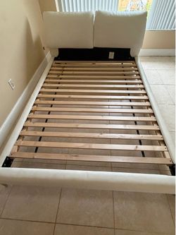 Queen size white leather bed frame.
