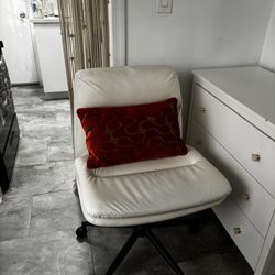 White rolling chair with pillow