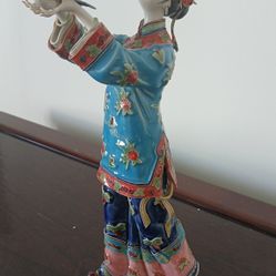 Shiwan Wucai porcelain figurine depicting a lady in traditional Qing dynasty-style garments