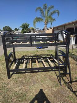 Black twin over twin wooden bunk bed.