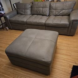 Gray Faux Leather Couch and Ottoman (L: 99" H: 34" W: 34")