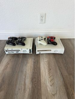 2 Xbox 360 with controllers