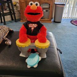 Sesame Rockin Elmo with drums and tambourine