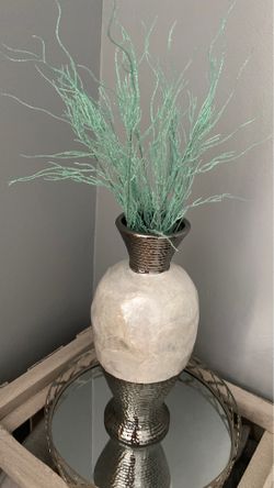 Seashell vase with fake plants