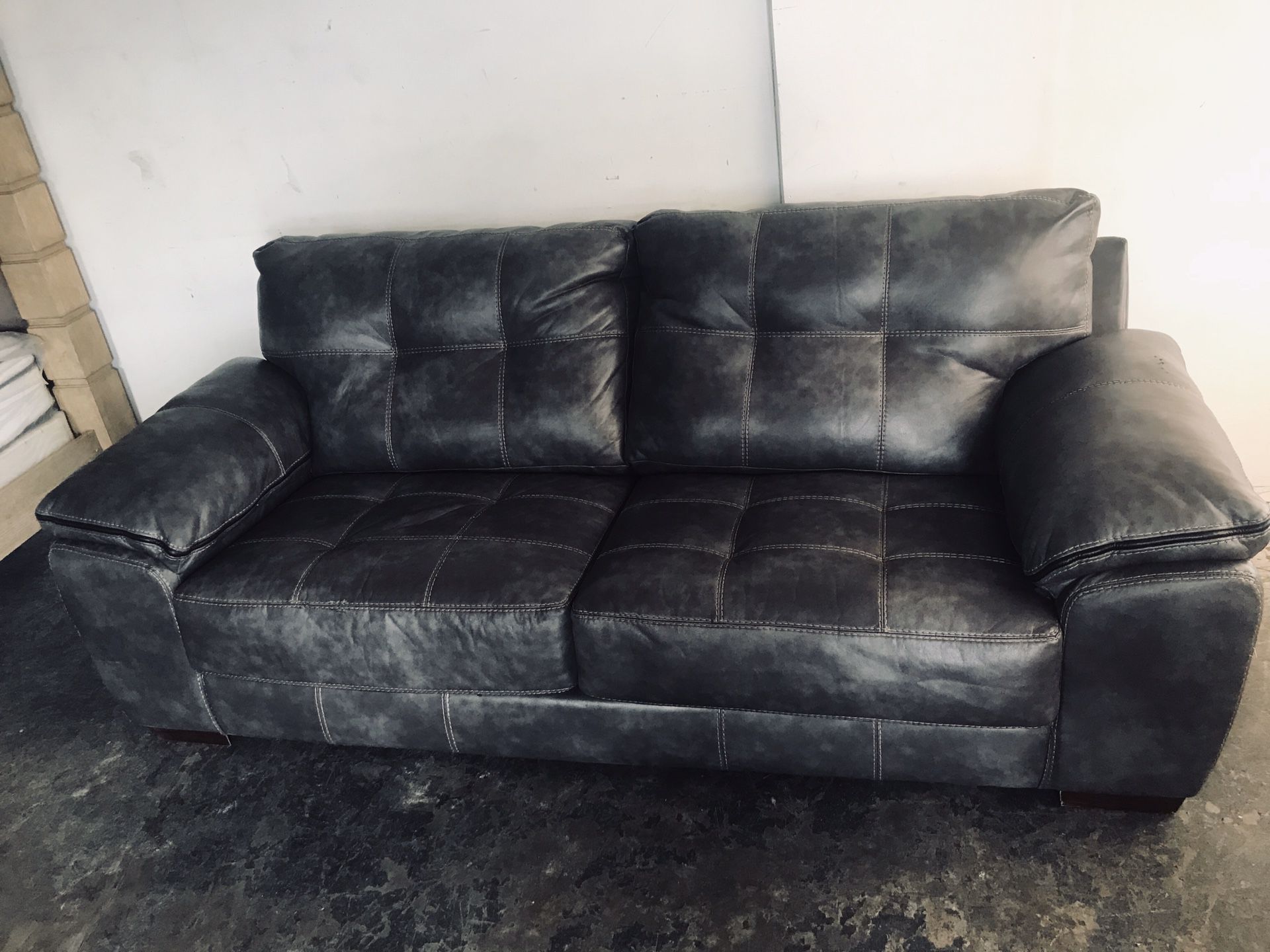 Dark grey stress leather couch