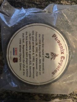 Coyotes hockey pucks with display stand.
