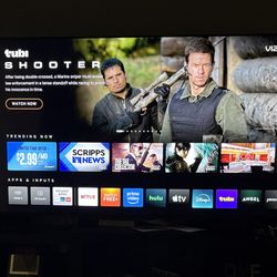 60 inch smart TV with dark wood stand