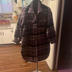 Long flannel coat says it’s a small but it actually fits like a large very warm and comfy brand. New. Never worn beautiful for these  cold  and wet.
