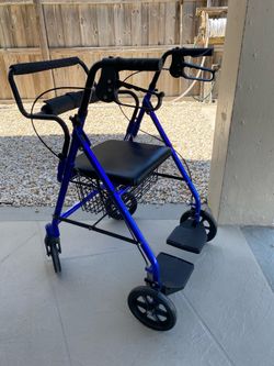 Rollator walker with seat and footrests