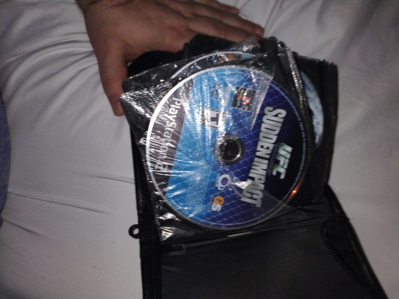 CD case Full Of PS2 & Xbox 360 Video Games