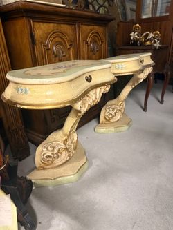 vintage Italian Rococo-style hand-painted and gilded wall console tables featuring ornate carved pedestal bases and delicate floral motifs with a crac