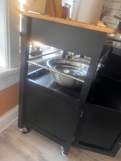 Kitchen storage cart with built in cutting board and wheels