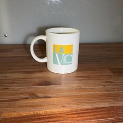 This is a white promotional mug with the Los Angeles Valley College logo.