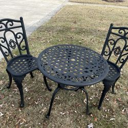 Vintage 3-piece black  cast aluminum outdoor bistro set  with arms, for front porch . Beautiful round table and two very sturdy chairs. 