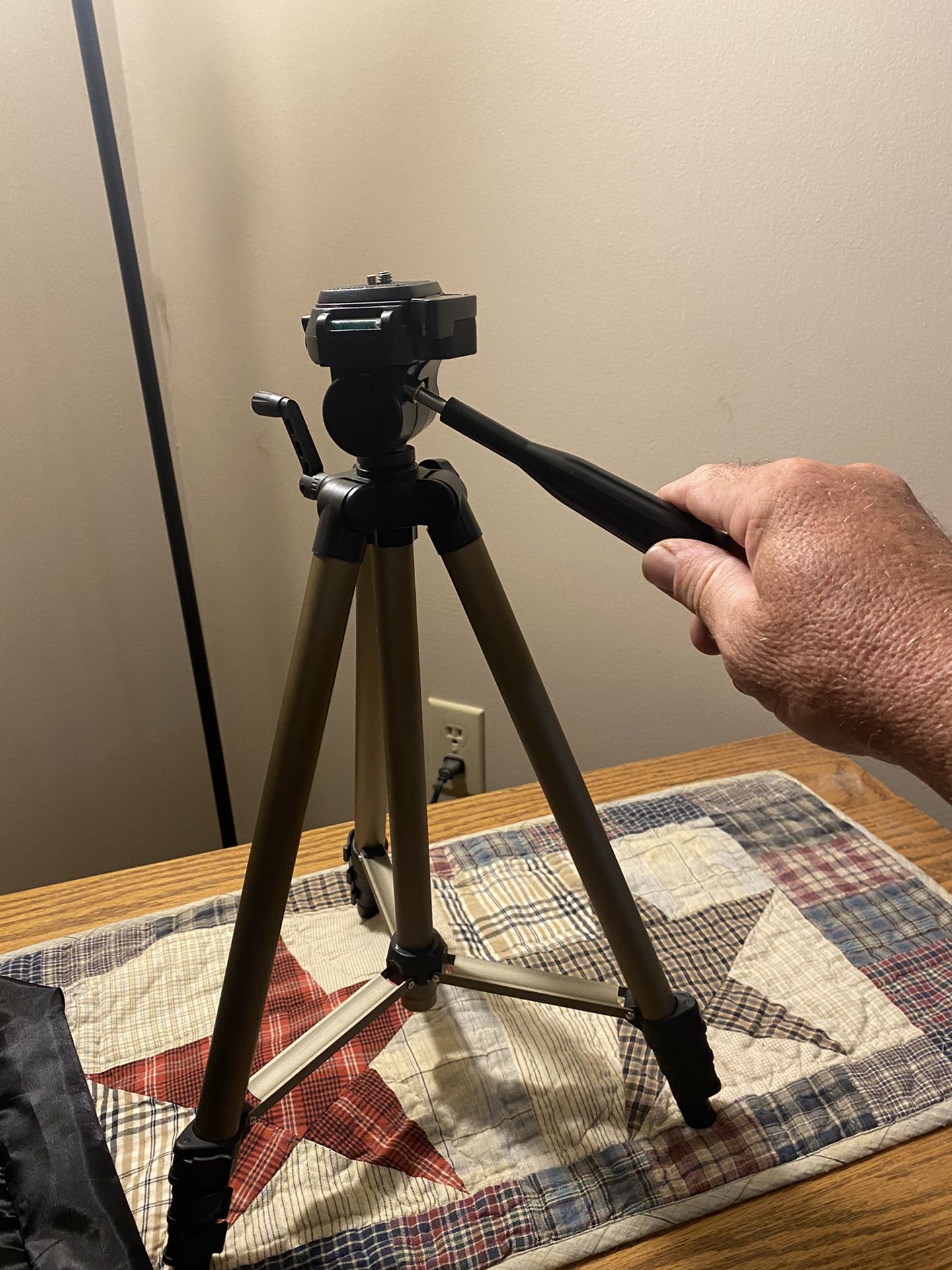 Camera tripod with crank height adjust.