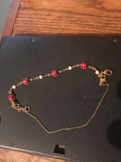 Woman’s gold ladybug bracelet