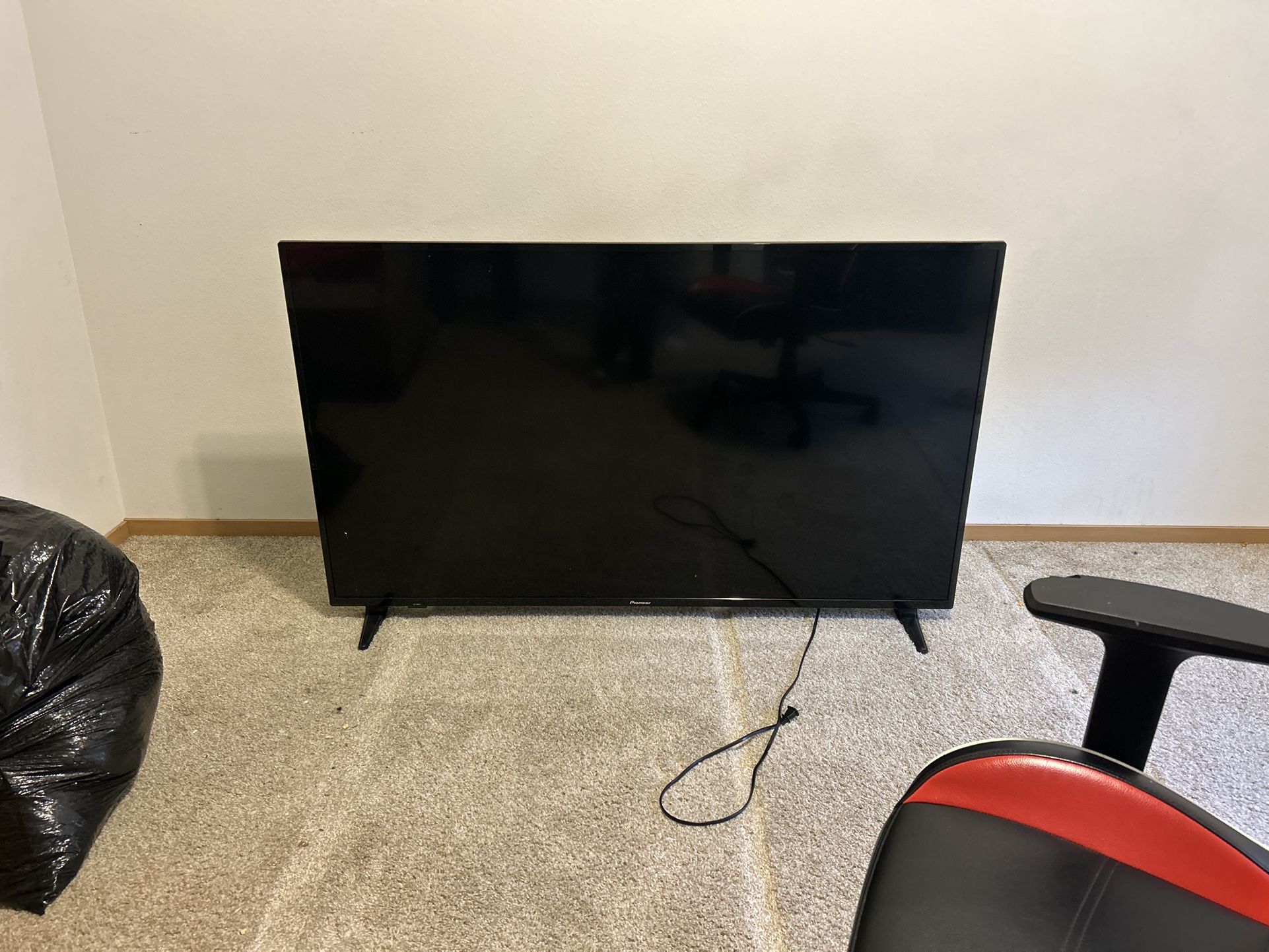 Two 65 Inch TVs One Is TCL Brand And The Other Is Pioneer Brand
