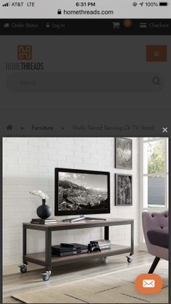 T.V. Stand With Cannister Wheels. NEW, Still In Box