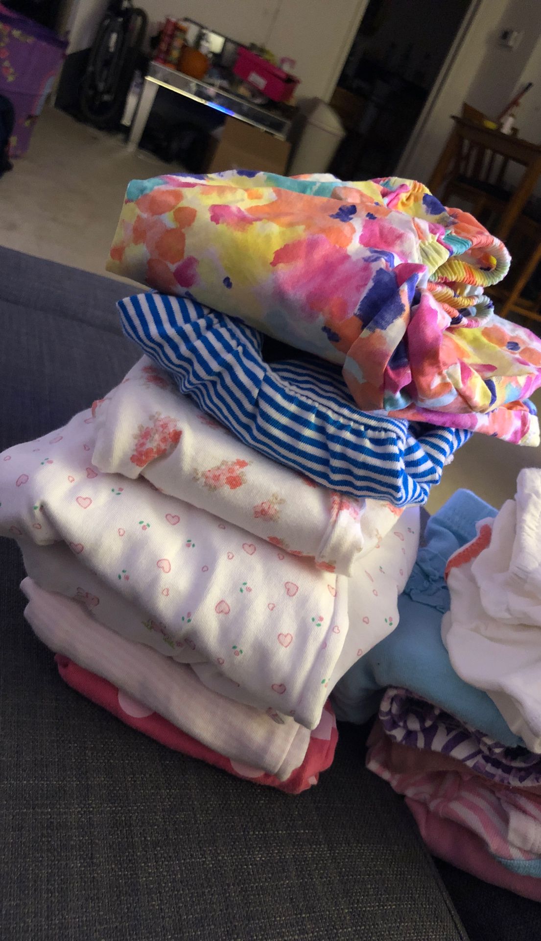 Pile of newborn clothes