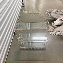 vintage three-tiered wrought iron shelf with glass shelves